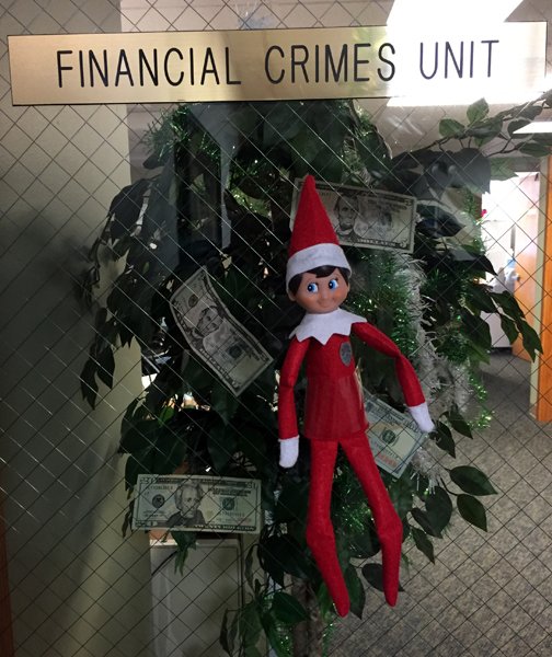 EverettPolice's tweet photo. Cuffs the #ElfOnAShelf is a somewhere near the Financial Crimes Unit. It looks like the detectives are throwing out a bribe!! #FindCuffs https://t.co/qIrT3TmTF3