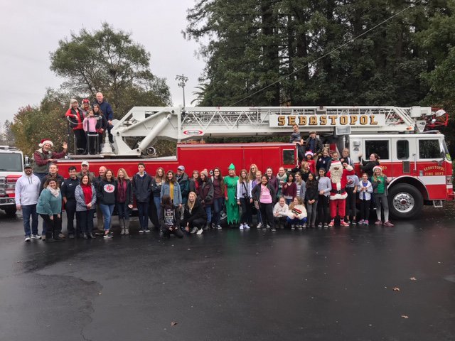 The Rotary Interact students from Brook Haven Middle School, Twin Hills Middle School, and Analy High School purchased, wrapped and distributed presents to 58 children in the West County today!   Santa, Sebastopol Rotarians, and our Amazing volunteer Firefighters had fun too!