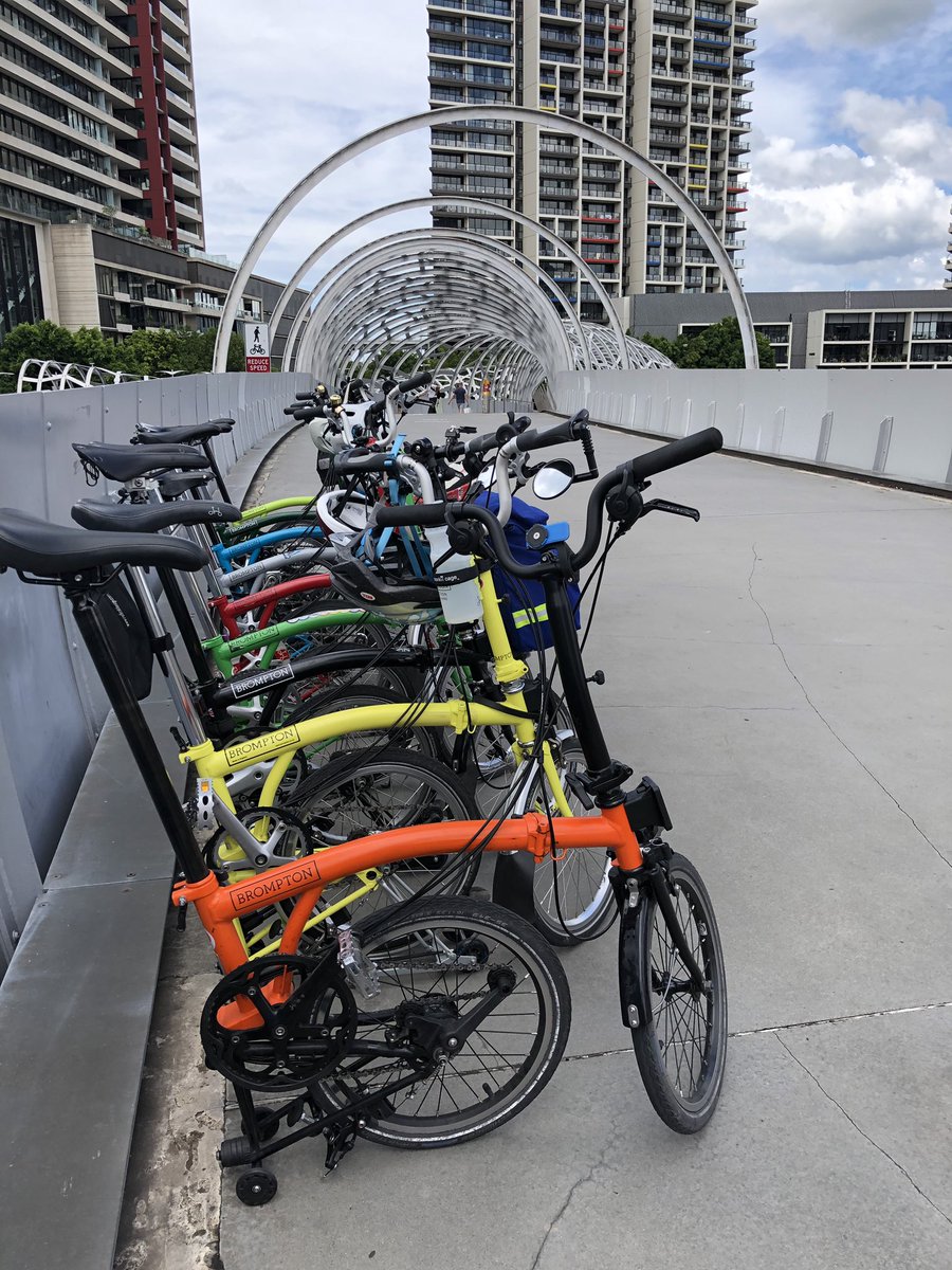 Brompton_MEL's tweet photo. On our way to our #BromptonHotLap at the #ShimanoSuperCrit today. Harking back to one of our first club rides, we met on #WebbBridge #docklands. I think we need more practice at doing the #bromptonlift... https://t.co/aHSmrU7hBQ