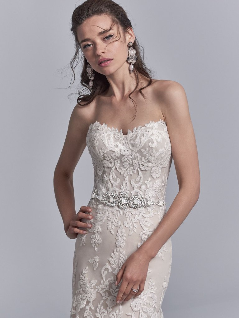 It is all about the details. We are in love with this Sottero&amp;Midgley beautifully beaded belt accented in Swarovski crystals, a strapless sweetheart neckline, and illusion scoop back with exposed boning accented in lace motifs. <a href="/maggiesottero/">Maggie Sottero Designs</a>
