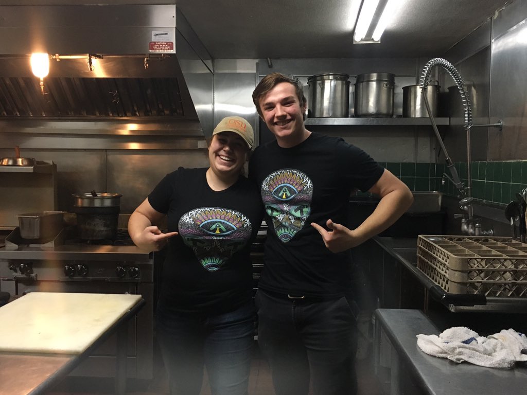 kmlorance's tweet photo. I listen to Alien Theorist Theorizing at work sometimes and one of my coworkers, Ian, started asking to listen to it every time we worked together.  Today Ian showed up at work in one of their shirts with a matching one for me! @truthisoutthurr https://t.co/AvL8UKpFBl