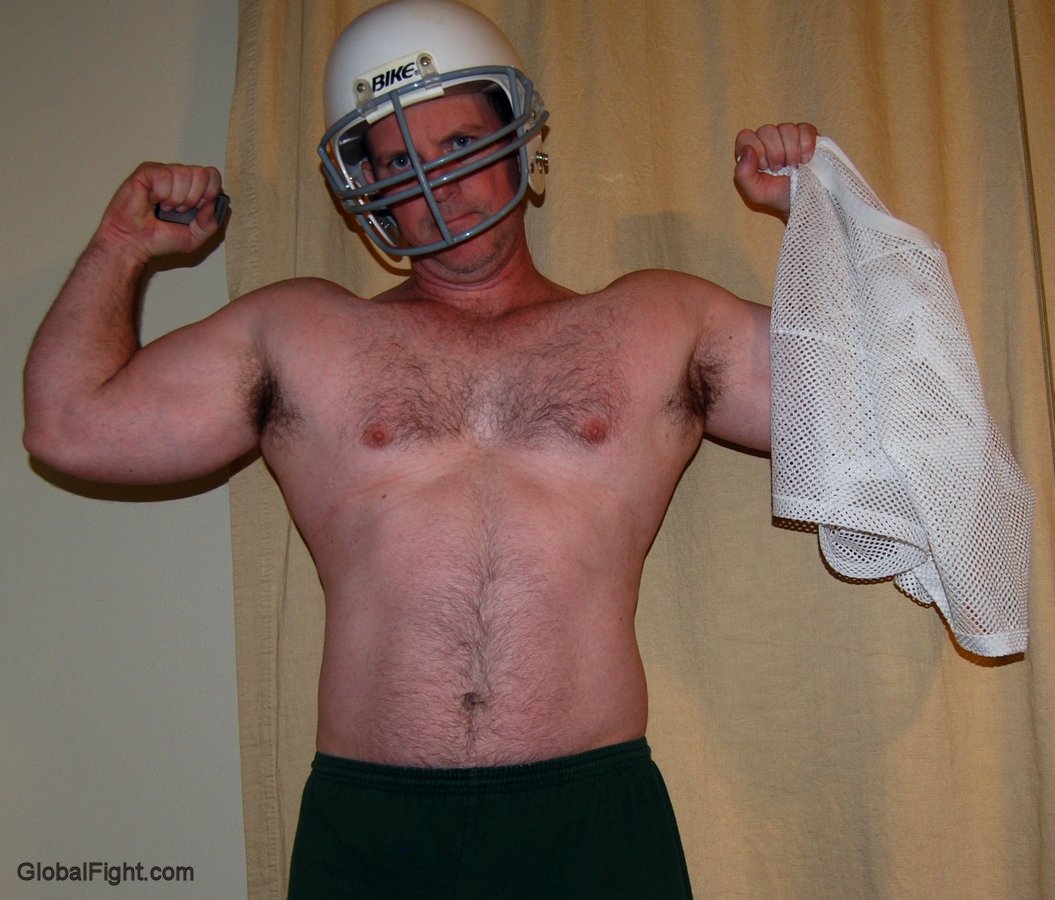 big arms football players removing jersey clothing hunky jocks