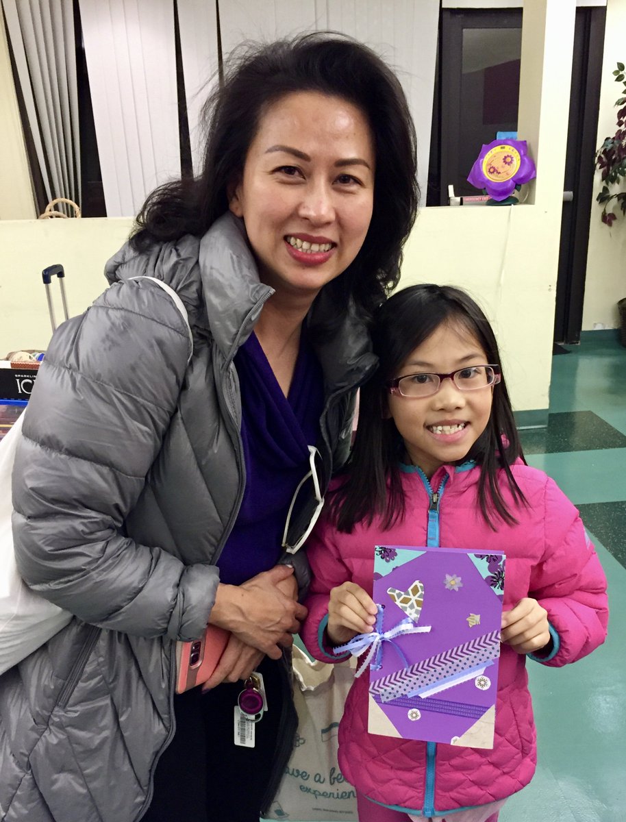 woman and child holding craftbook
