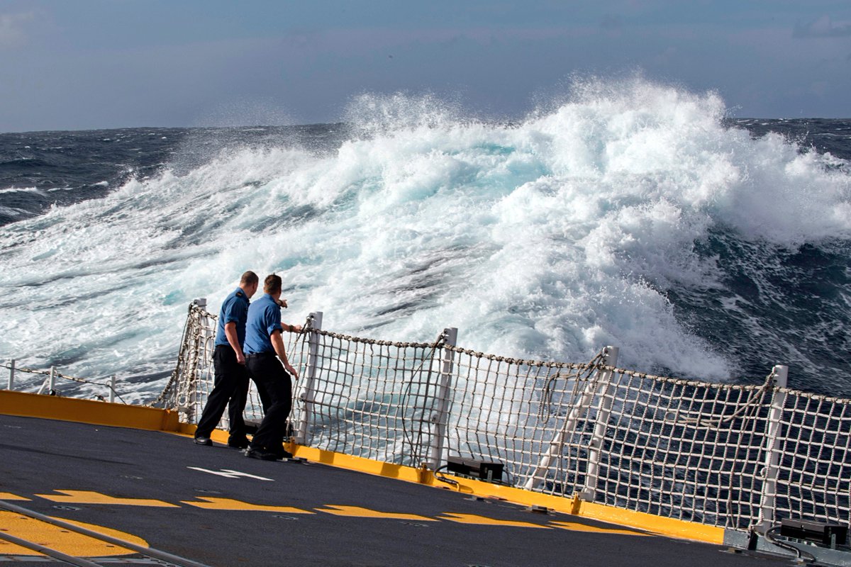 CanadianForces's tweet image. #CaptionThis photo! #CAF members observe rough seas from the flight deck while #HMCSCalgary transits home during #OpPROJECTION in the Pacific Ocean.