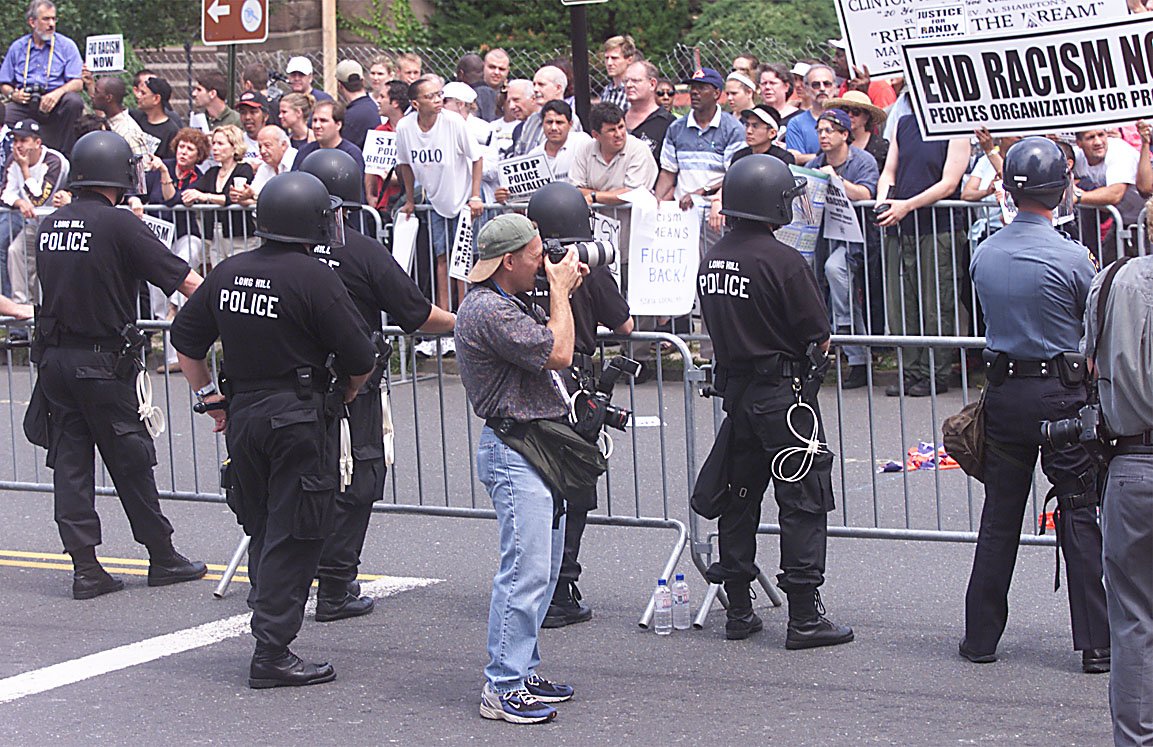 BobKarpDR's tweet photo. Some favorite moments from my career: As a staffer for the Herald-News (Photo by @johndecker 1987) @jim_anness &amp; I @EllisIsland rededication 1990. @DouglassCrouse &amp; I in Colombia, 2000. Shooting a 2001 White Nationalist rally in #Morristown #Goodbyetour https://t.co/gwkxZjEpi7