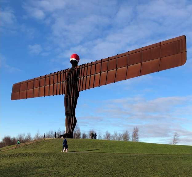 bbcnewcastle's tweet photo. A santa hat has appeared on Gateshead's Angel of the North sculpture. It's not yet clear who placed it there. https://t.co/FKZmtjYcNE