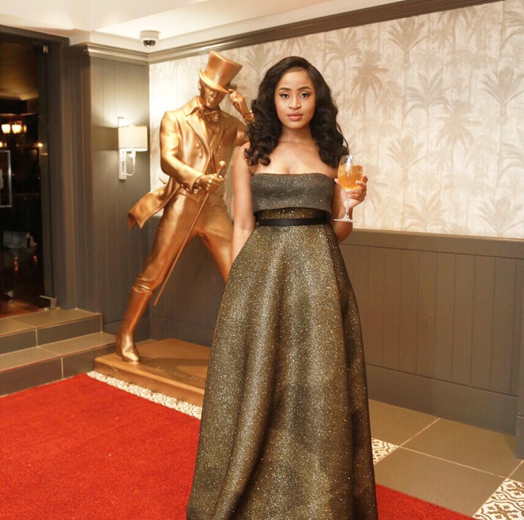 OfficialFaddic's tweet photo. @Tumie_Nthutang sparkling in a @faddicofficial black and gold dress for the #JWcodeblackbots https://t.co/4NFiiFi6h7