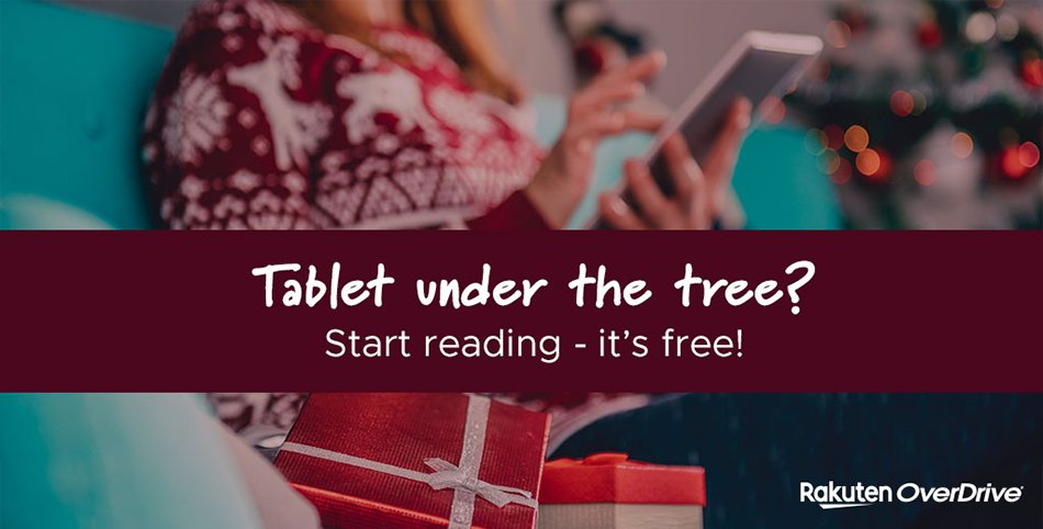 a photograph of a person in a holiday sweater reading on their tablet