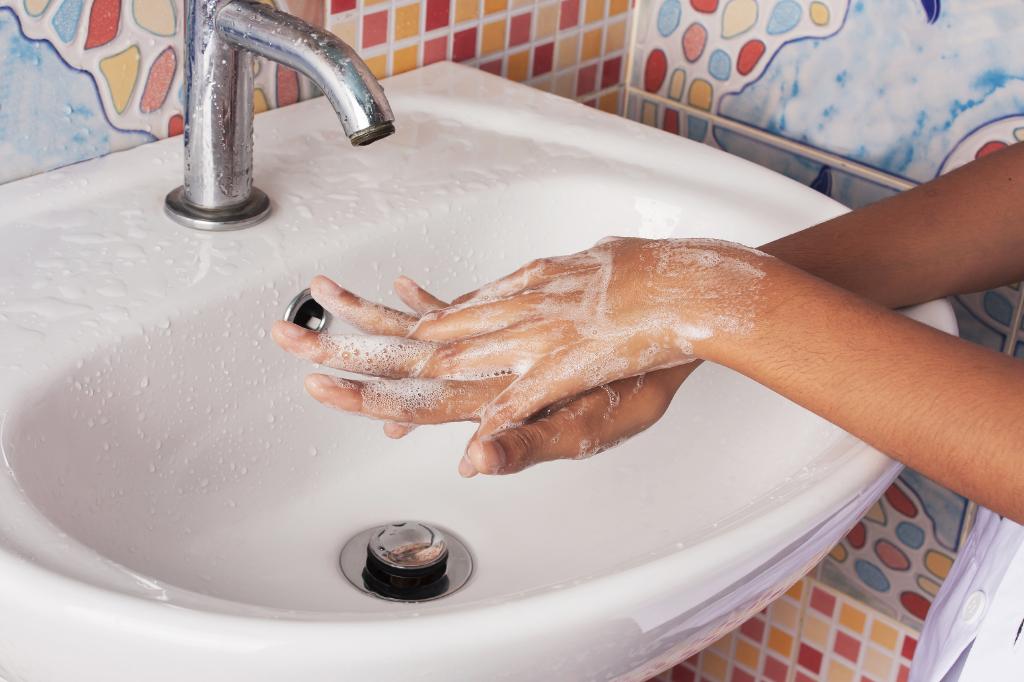 Woman washing hands. 