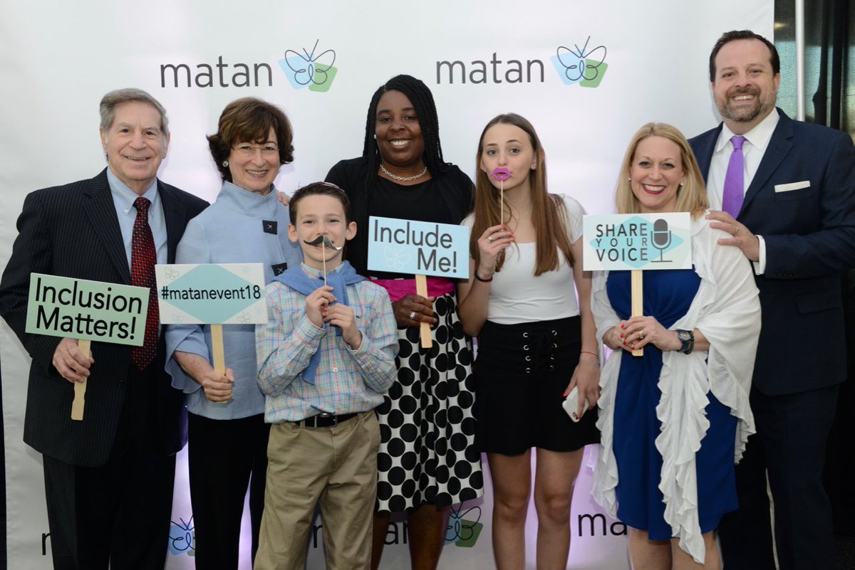 People holding signs with text, “Inclusion Matters” and “Include Me.”