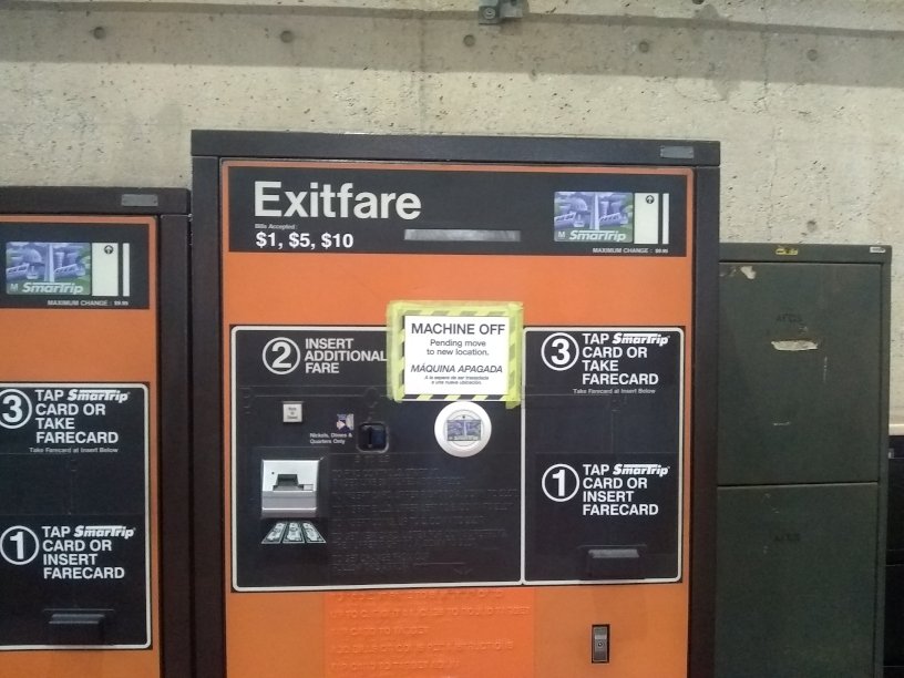 Inside Takoma Metro station, Exitfare machine with taped-on sign including text "Machine off pending move to new location."