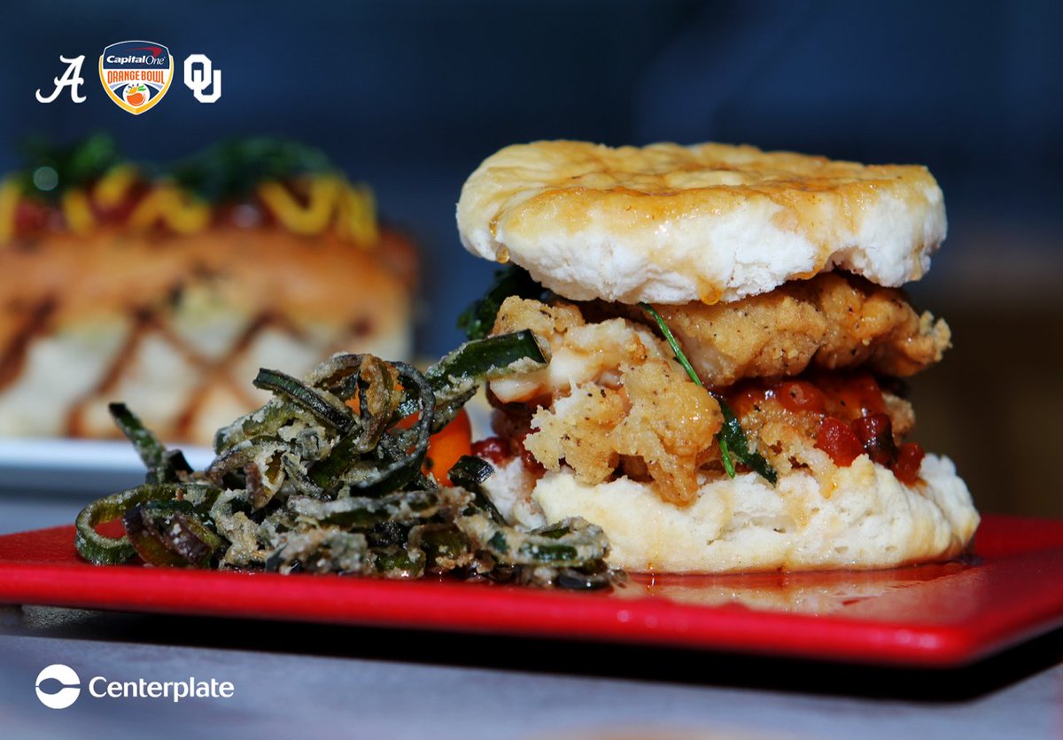 mikesunx's tweet photo. #CFBPlayoff #OrangeBowl Hard Rock Stadium chef Dayanny de la Cruz from @centerplate is rolling out some new #food items for #Alabama #Oklahoma game. That includes fried chicken sliders,  smoked brisket sliders and Alabama themed pork rinds. #RollTide https://t.co/r0JnE6D0r4