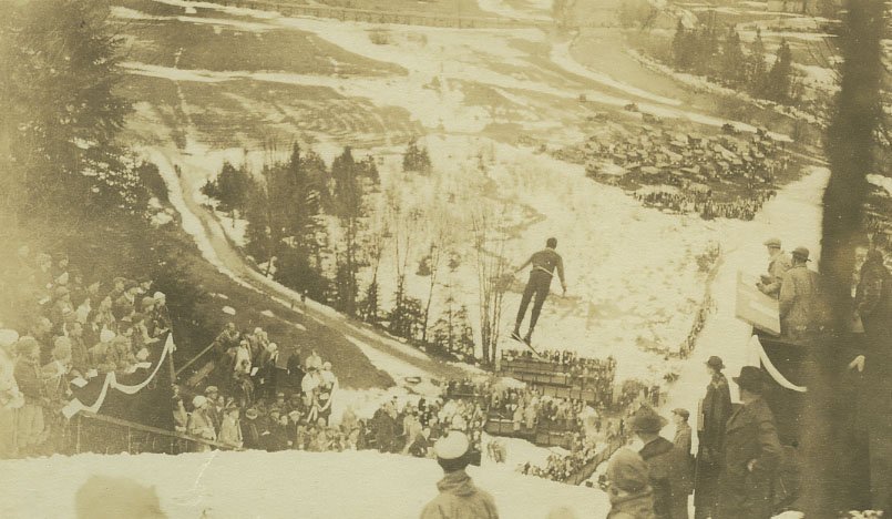 theADKX's tweet photo. The New Year’s Masters Ski Jump competition continues today in Lake Placid! Check out this 1930’s photo from our collection showing a ski jumper from the top of the Lake Placid ski jumps with spectators watching. #adkx #skijump #adirondacks https://t.co/yzXRpD4yd1