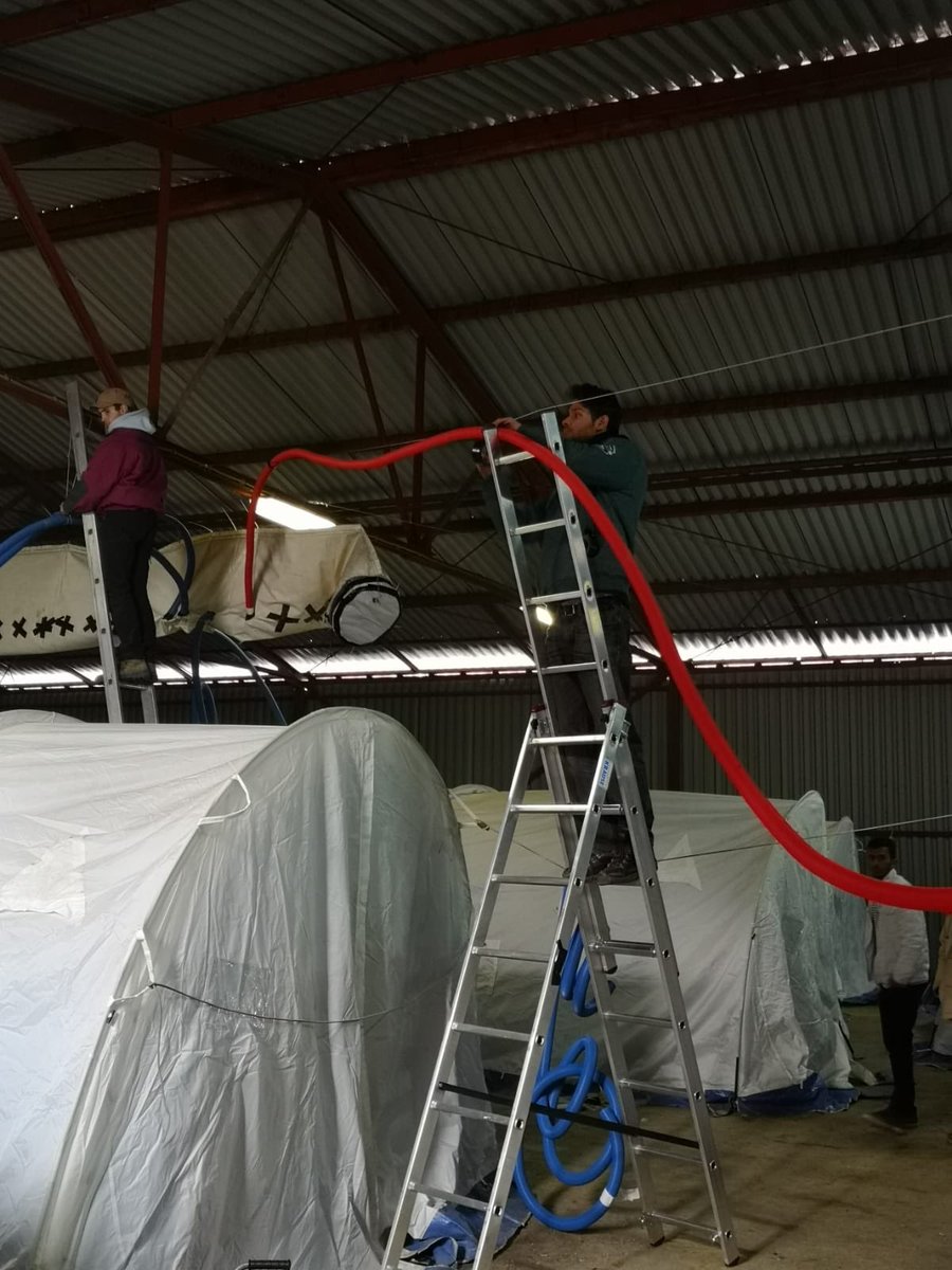 aid_brigade's tweet photo. Yesterday we built a system to heat up 15 tents in a wearhouse in Ušivak camp. The idea was to get the heat from the big sleeve of the main heaters into the tents with a series of pipes so that's what we did! It was a hard working day but it was worth it! https://t.co/dwZrJ4jqJo