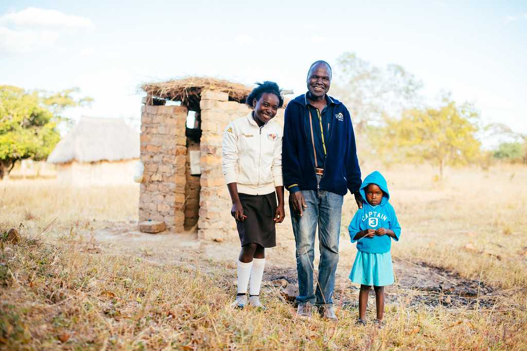 toilettwinning's tweet photo. It's a #HappyNewYear for Febby and family in Zambia... They have a new toilet, thanks to you. Now, they no longer go to the toilet in the bush, where Febby was once bitten by a snake. Her dad, Simon, says: ‘Our toilet means we have less illness and we have dignity!' THANK YOU! https://t.co/7Jm7B3C0xn