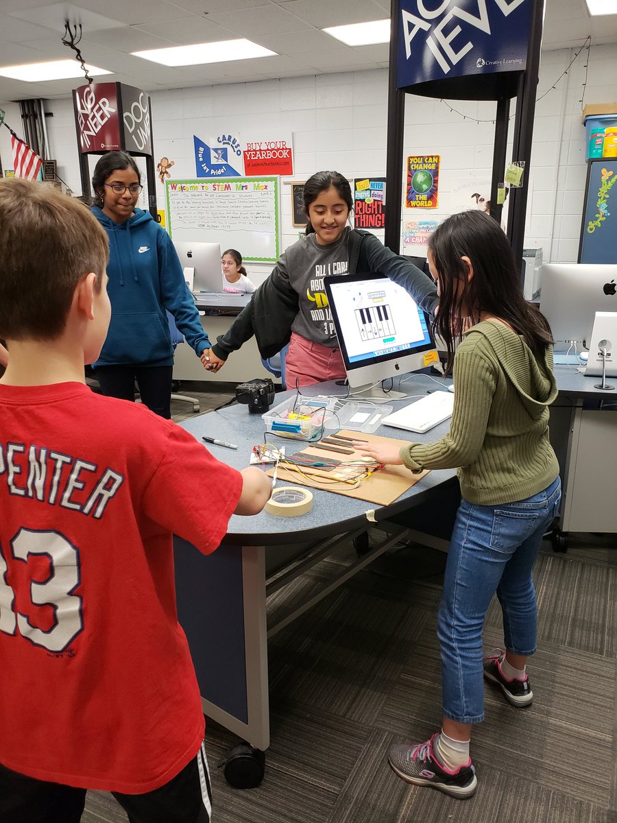 StaceyLMax's tweet photo. Human chain playing the piano with makey-makey in STEM today. #carusoway #engage109 @109Caruso https://t.co/jvtzl2c6Ng