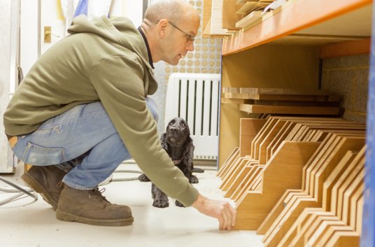 Inspecting our stock of mahogany body billets under the expert eye of Angus the dog.