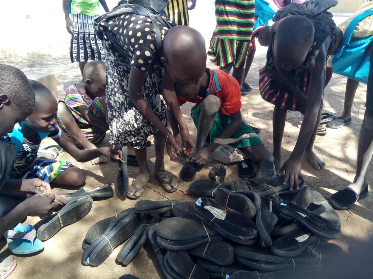 kootoroschool's tweet photo. Fitting in shoes donated by #AfyaTimiza Lokichar office!  Thank you @UNICEFKenya for school bags too!  @MumbiKaptere https://t.co/DHIkFg9BcQ