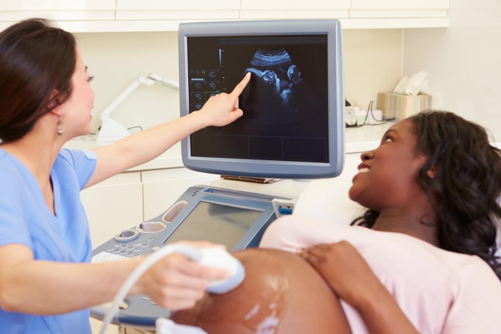 Pregnant woman receiving an ultrasound.