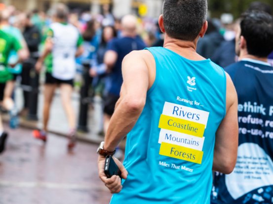 A runner raising money for the National Trust by entering a running race.