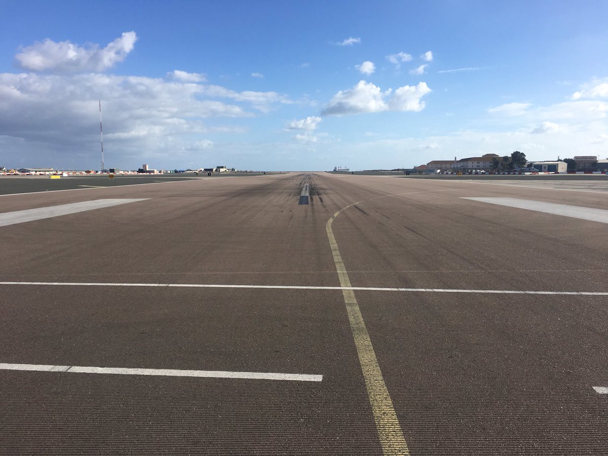 Gibdan1's tweet photo. A unique view down the center line to 09 and 27 runway at #Gibraltar whilst walking across to get home #avgeeks #potn #uniquerunway https://t.co/ammMO396IW
