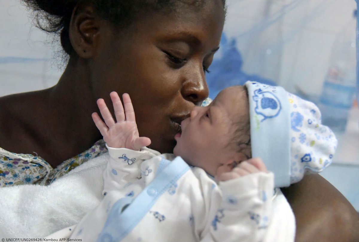 A mother kisses her newborn daughter at a hospital in Abidjan, Ivory Coast.
