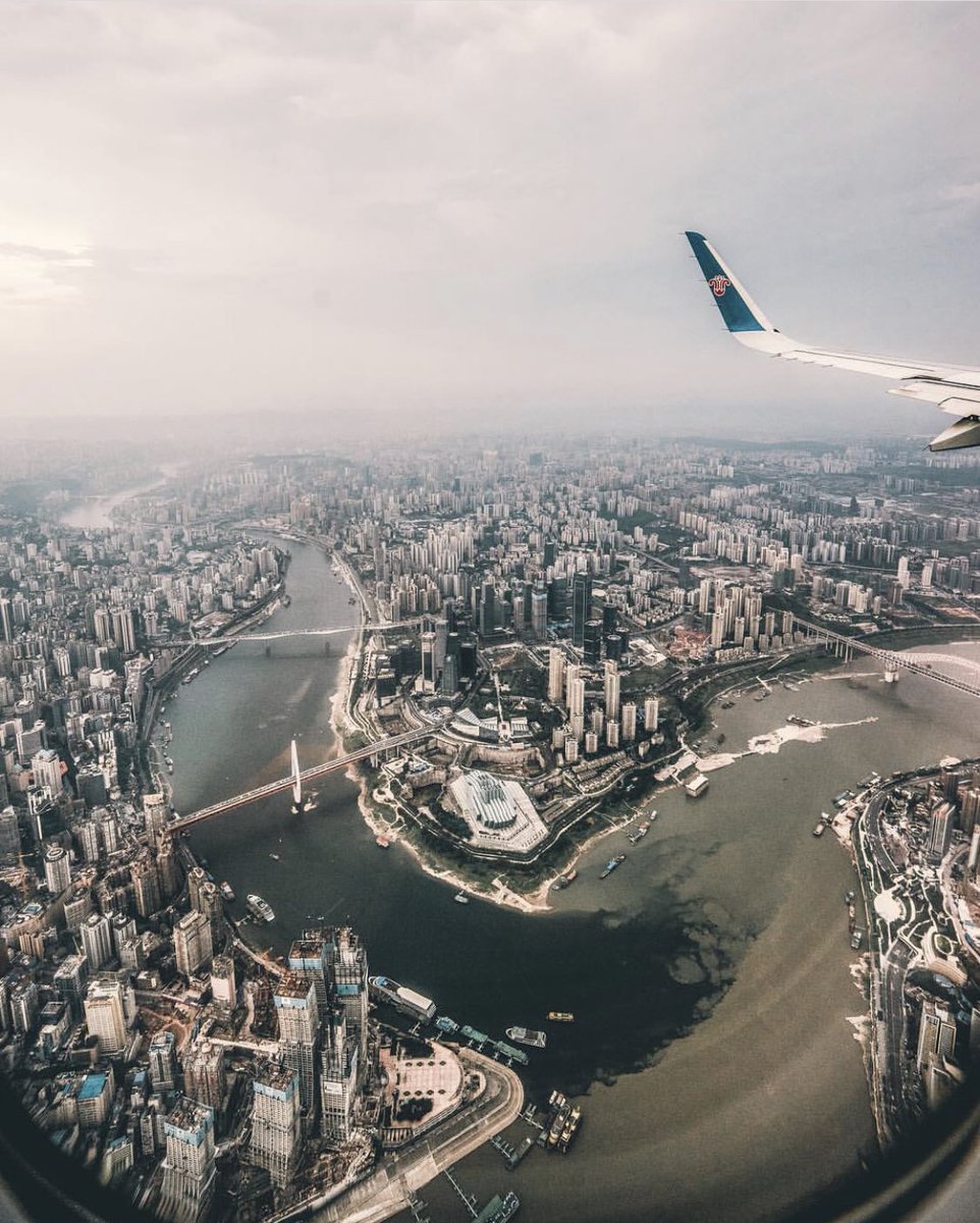 A bird's-eye view of Chongqing by local photographer Zhu Wenqiao on Instagram (wenqiao.z). You can see the Chongqing Raffles City under construction in the foreground between junctions of Jialing(Green) and Yangtze River(Brown). All these buildings didn’t exist in 1980s