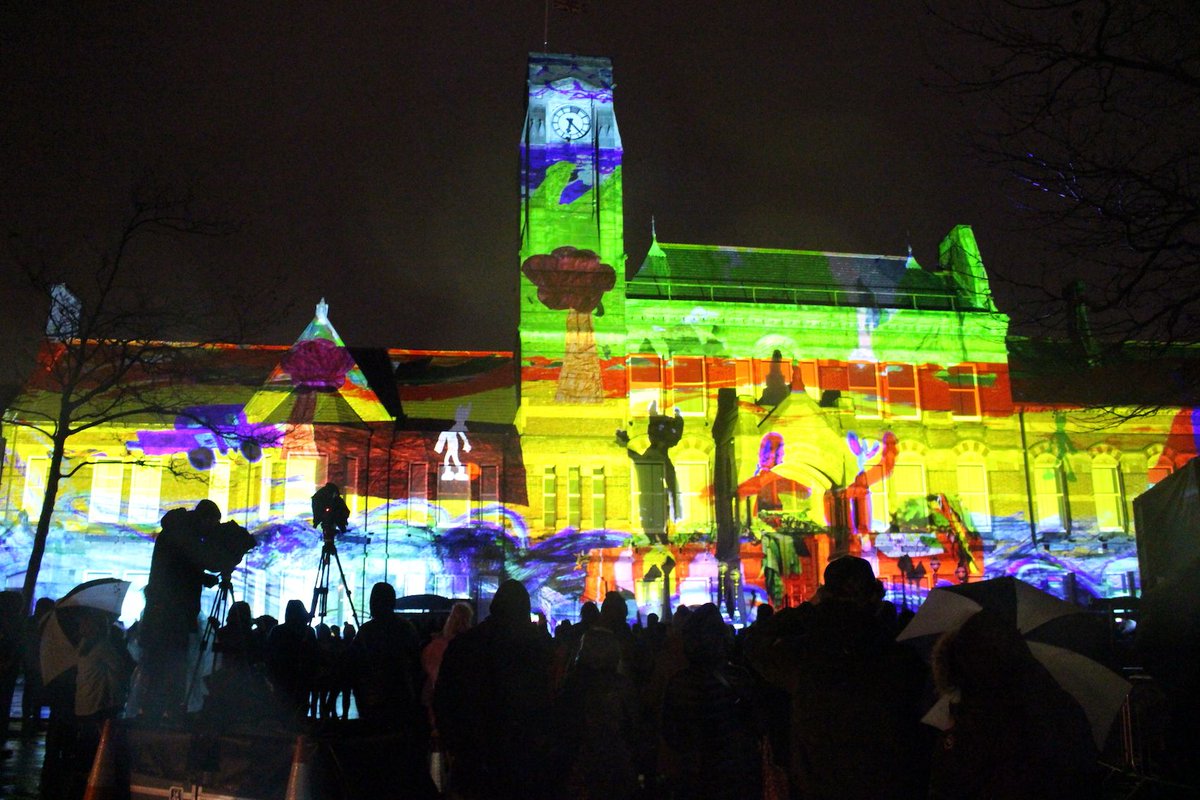 TheHeartofGlass's tweet photo. Today's weather reminds us of the wonderful #StHelens150 &amp; #DaDafest18  finale event when over 500 people braved windy &amp; wet conditions to watch the Town Hall be transformed by 'We Are Still Here' created by artist @SMckeownArtist &amp; @StHelensCDP 
📷 Andy Salkeld © Simon Mckeown https://t.co/VfJNbHZmm7