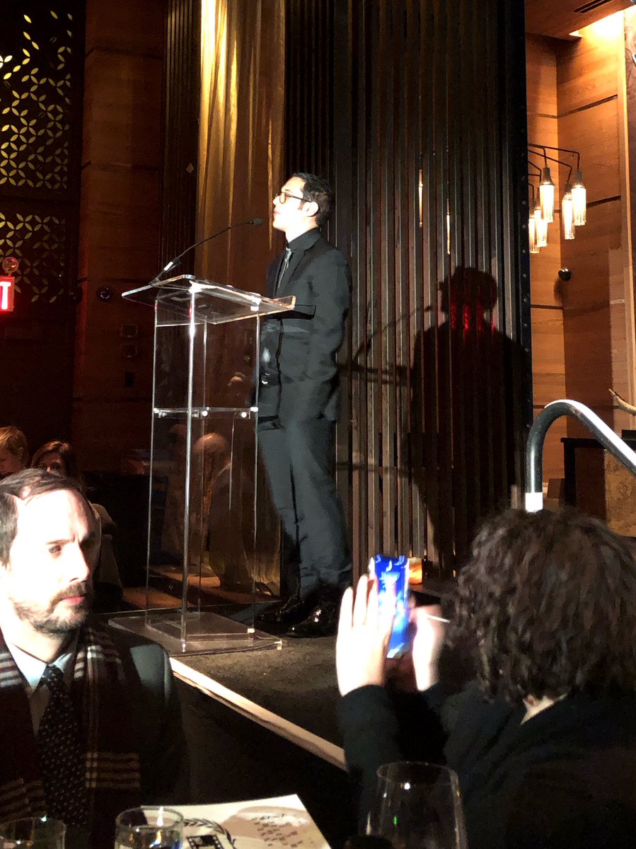eug's tweet image. Annual New York Film Critics Circle dinner underway: @EricKohn saluting tonite’s winners, “While our apparent President tried to build a wall, down south, ROMA gave us a window.” Eric’s wife Liz, lower right, snapping his photo. Cheers!! #NYFCC