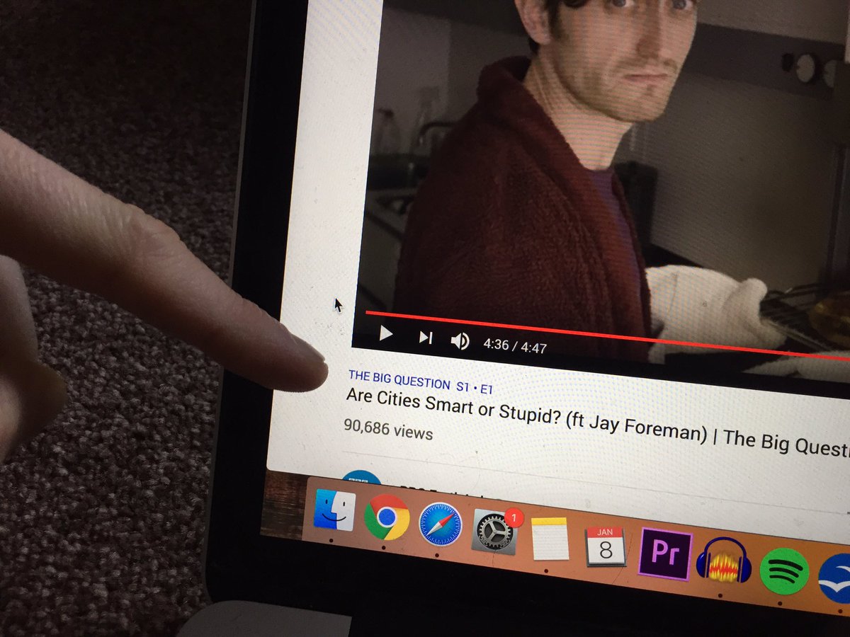 My laptop screen. My finger points to blue text above the YouTube video title that says “The Big Question, S1, E1”