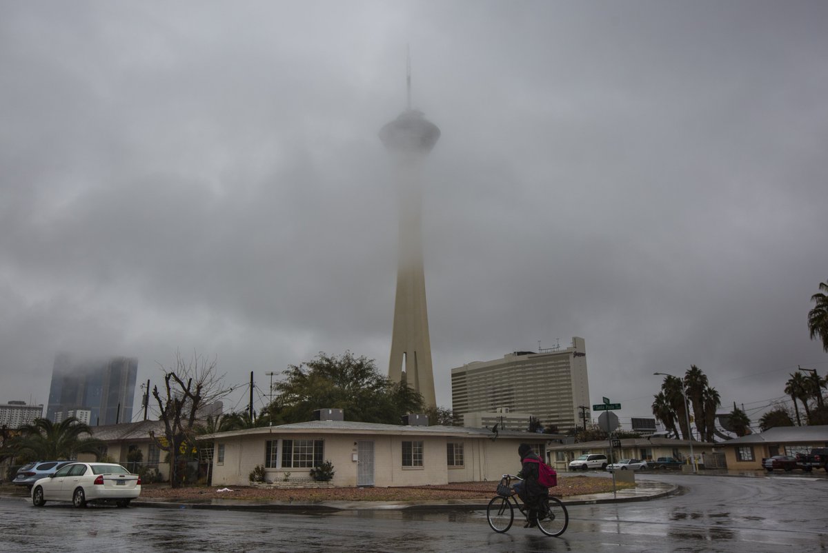 The <a href="/LVStratosphere/">STRAT Vegas</a> partially obscured by fog and cloud cover during a rainy day in Las Vegas