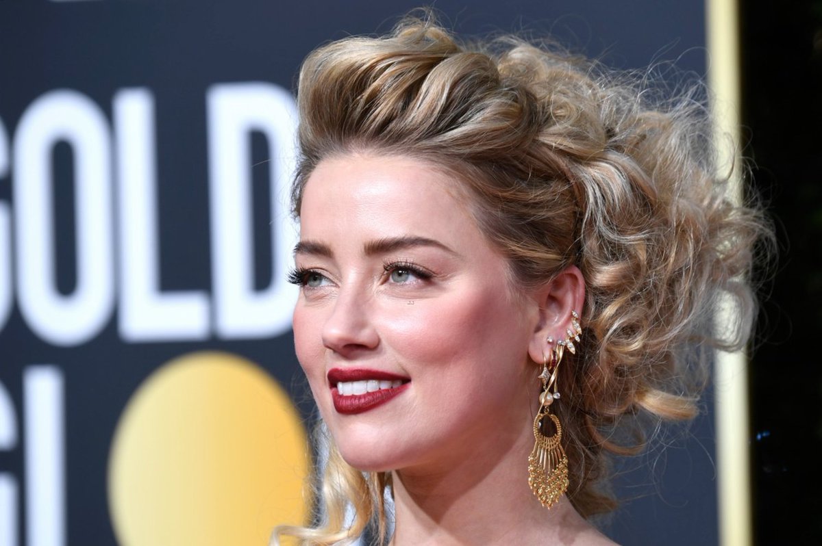 Amber Heard wearing a stack of earrings 