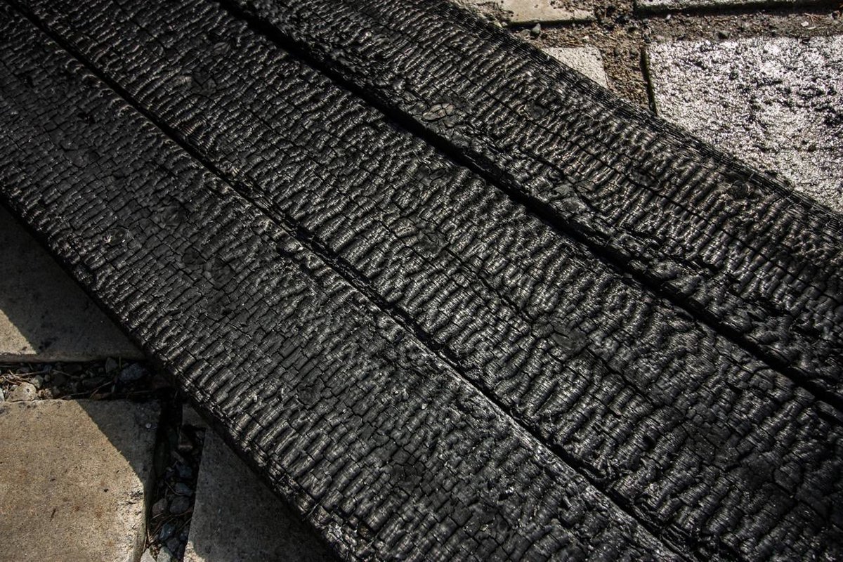 The charred wood is salt water resistant and extremely resistant to heat, protecting the house interior from the summer sun and at the same time keeping bugs and insects out. I've heard of walls lasting over 100 years without any maintenance at all. It's also cheap, easy to make.