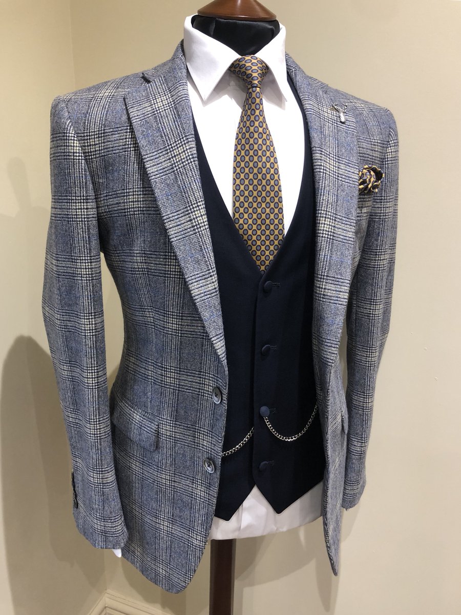 The key to wearing bold pattern is to combine with a simple block colour. We love this grey check jacket with a contrasting navy waistcoat - finish with some navy trousers and a brown brogue 👌