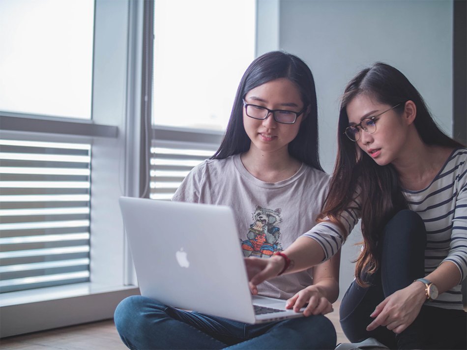 two women looking at a laptop together