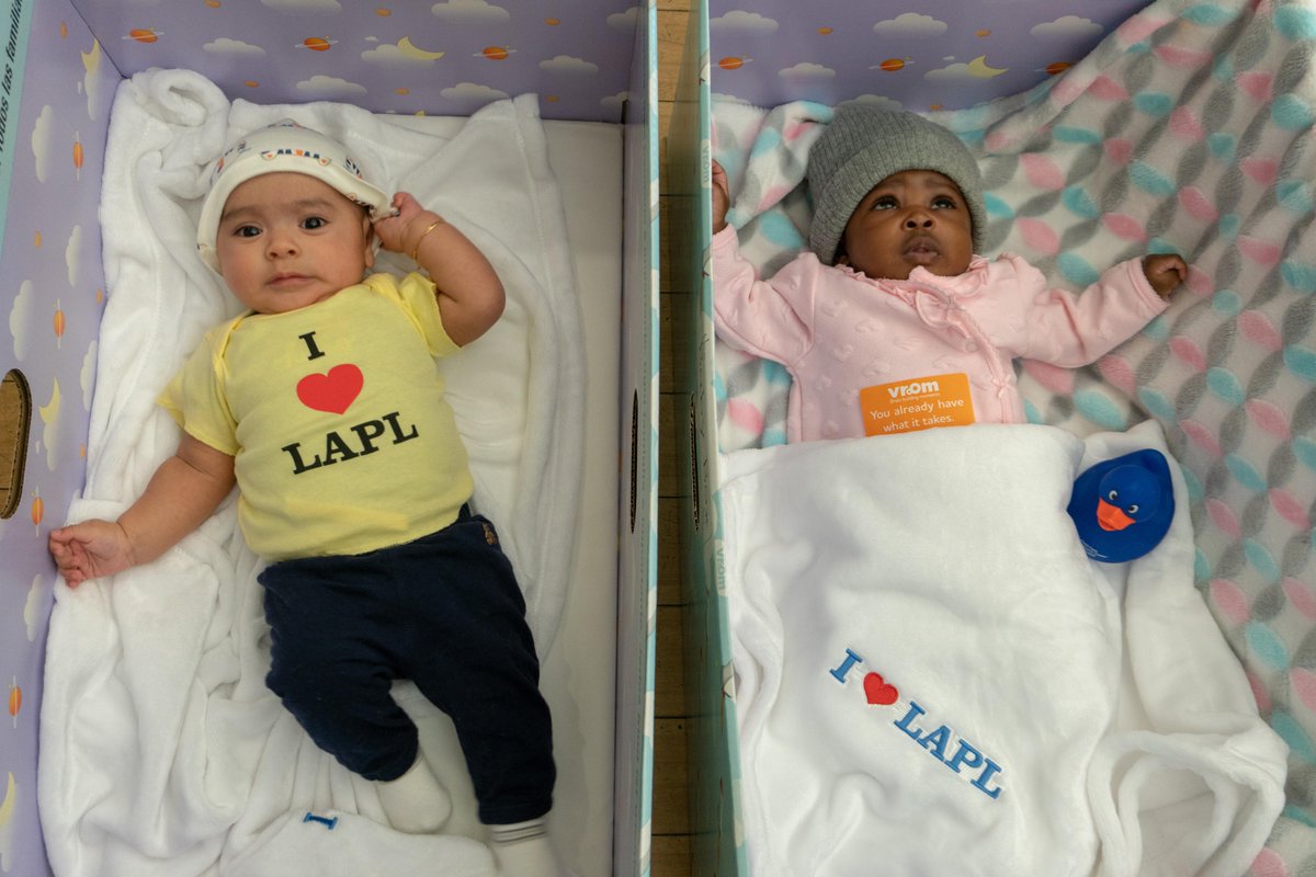 two babies in box beds