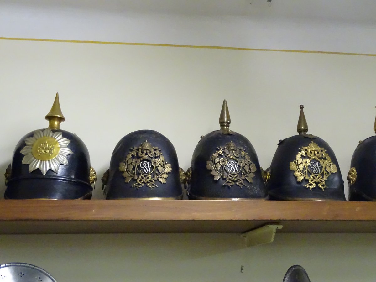 The Swiss Guards' uniforms have gone through various iterations and phases, including a Prussian and British phase in helmets as here, before the more recent reversion to the Renaissance forms. If needs be, the axes and maces are on standby....