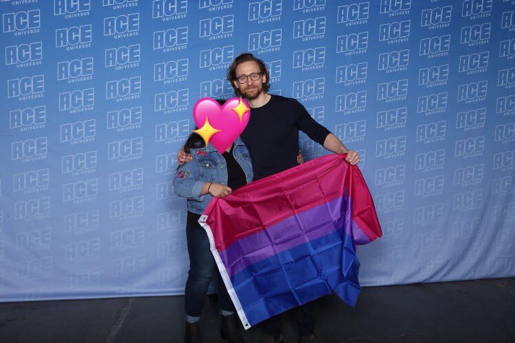 TOM HIDDLESTON WITH THE BI FLAG I LOVE THIS SONG