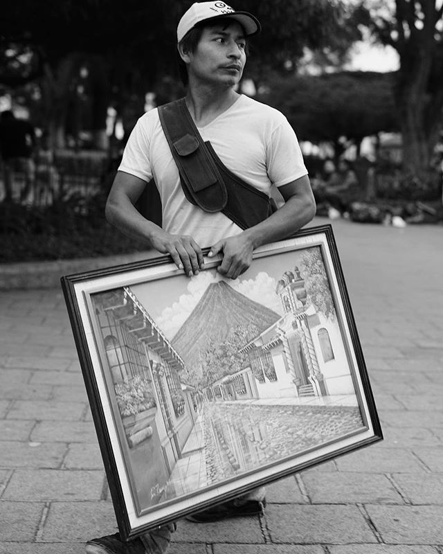 “A man walks across Parque Central with a painting of Volcan de Agua”
Photography from Guatemala, by Creagh Cross! <a href="/creagh/">Michael Creagh</a> bit.ly/2FTZ2mm