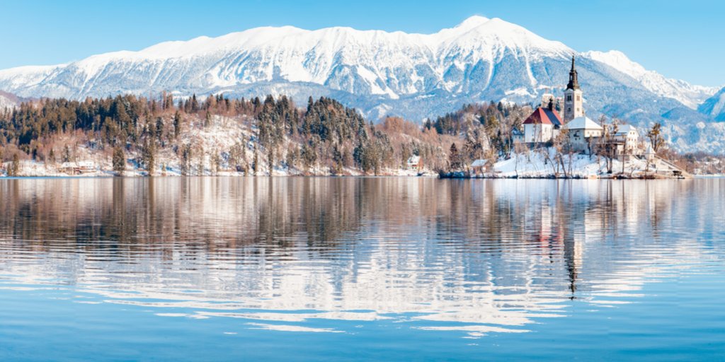 Beautiful view of famous #Bled Island at scenic #LakeBled with #BledCastle and #JulianAlps at sunrise in winter, @SloveniaInfo