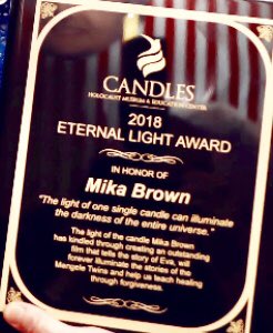 EvaMozesKor's tweet photo. Last night I gave out  3 CANDLES Eternal Light Awards to the 3 co-producers of “Eva A-7063” 1. Lloyd Wright dirct. of WFYI, 2. Ted Green-film coproducer &amp; 3. Mika Brown-film coproducer. It reads “THE LIGHT OF ONE SINGLE CANDLE CAN  ILLUMINATE THE DARKNESS OF THE ENTIRE UNIVERSE”! https://t.co/N3lIRZ3QZH