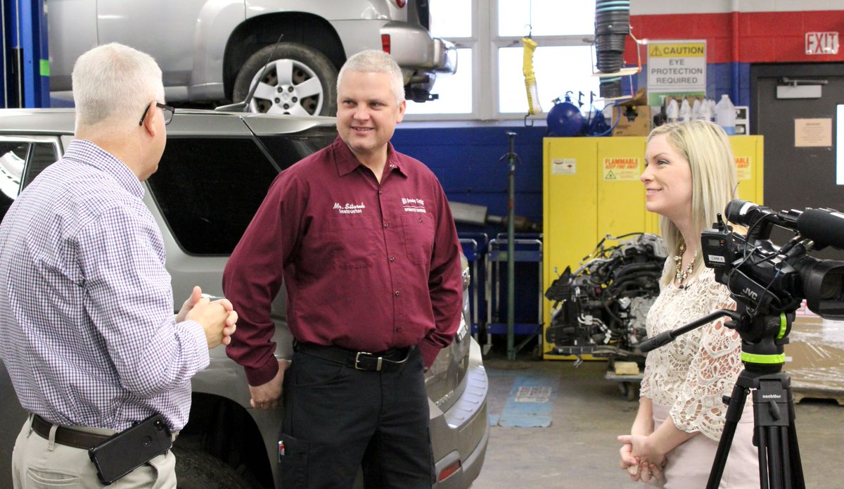 E2CCB's tweet photo. Ali Touhey @WKBW interviews instructor Scott Sitarek and students enrolled in the Automotive Technology class at the Ormsby Educational Center as they prepare for the 25th Annual NFADA Ron Smith Memorial AutoTech Competition. #BOCES #CTE #OpportunityMakers #NFADA https://t.co/4Y5GMO3eAd