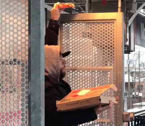 chicagotribune's tweet photo. Watch this anonymous Red Line hero use the CTA's heat lamps to warm his pizza: https://t.co/F6pqbPW90m https://t.co/JRAaJu66kZ