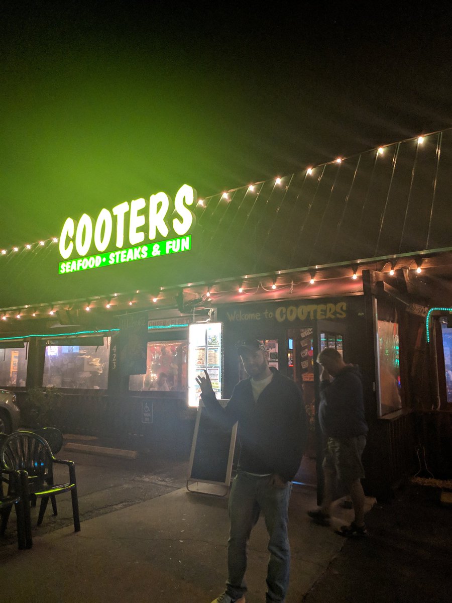 NavigatingSarah's tweet photo. My BF standing proudly in front of Cooters - the hidden gem of Clearwater Beach 😂 https://t.co/VlL7sdXZIu