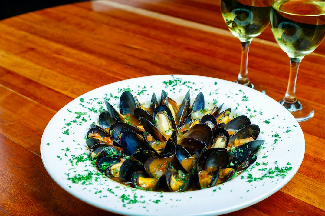 Friday night feast...French Country Mussels, steamed in a white wine, garlic + tomato broth, served w/ plenty of crunchy french bread...