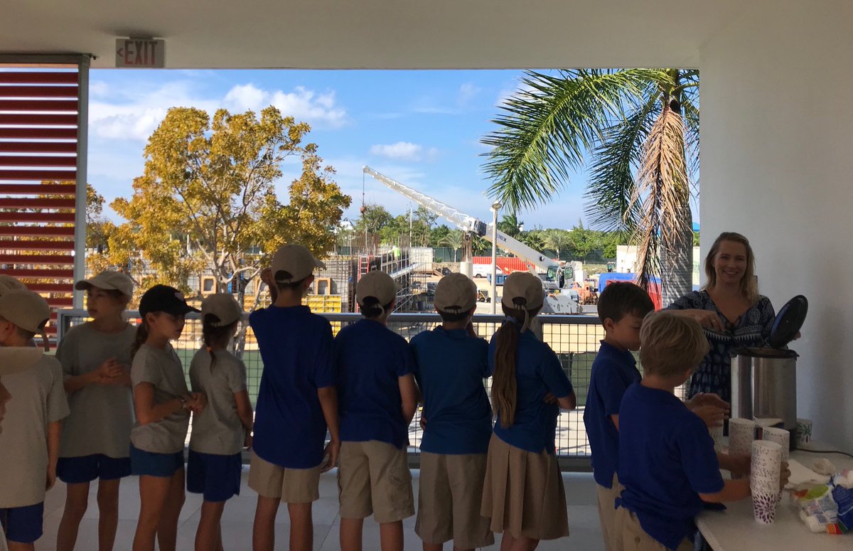 MeadeMelody's tweet photo. Caught reading over our winter break. Let’s celebrate with hot chocolate on a cool Cayman day! #CISinspires #CISCaughtReading 
(Don’t mind the construction cranes behind you, up goes our EC Center for future readers! https://t.co/Kl8HgEO2bg