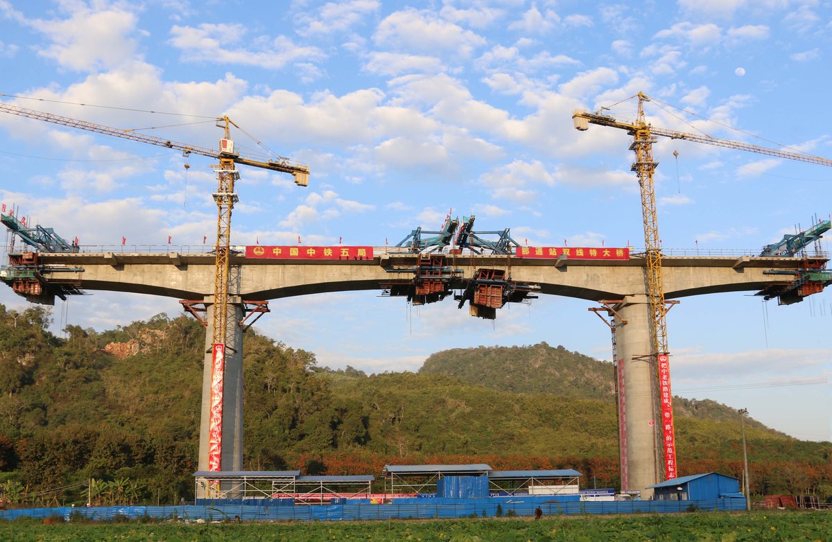 Chinese firm completes beam closure along China-Laos railway. The 414 km railway links northern border of Laos with capital Vientiane http://xhne.ws/GQdIO