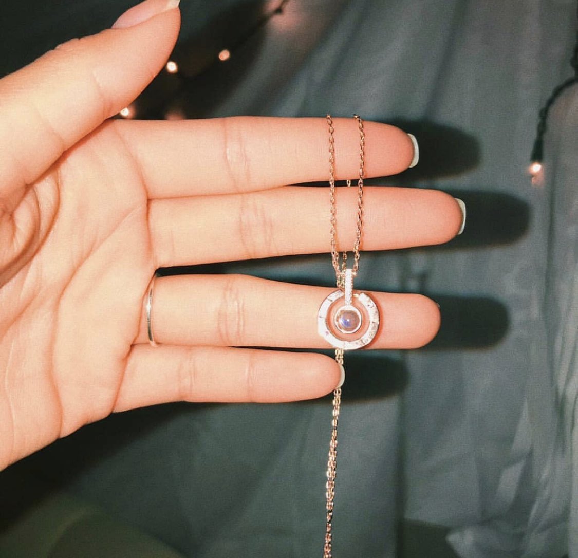 AIphaAmbassador's tweet photo. my boyfriend got me a necklace that when you shine a light thru it, it projects “I love you” in 100 different languages 😭❤️ https://t.co/zNFuYETPin