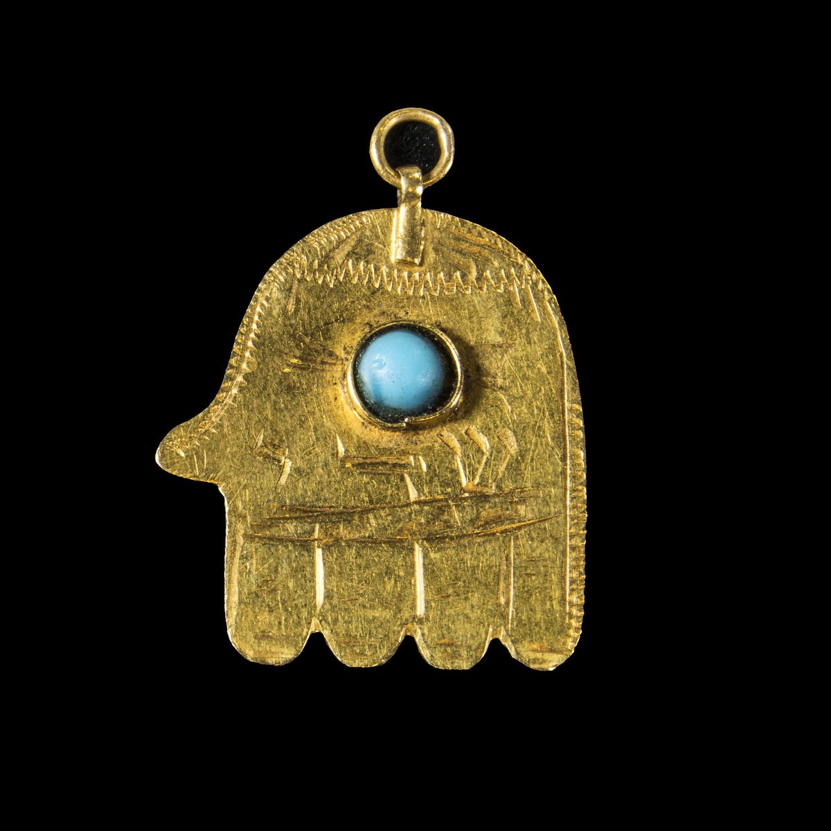 Khamsa shaped amulet displayed at the "Out of the Blue" exhibition. Gold, stone, Iraq, ca. 1940.
Courtesy of the Gross Family Collection, Photographer: Moshe Caine