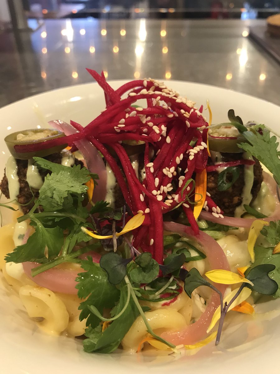 MAC MONDAY!!! 🧀 

Time to start your weekend off right by having our Old fashioned, crispy bread crumb baked, ooey gooey Mac and Cheese topped w/ pickled jalapeños, onions, turnips, falafel, tahini sauce, garnished with scallions and cilantro!